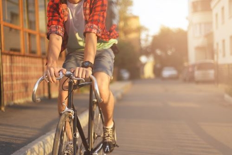 man riding bicycle down the street