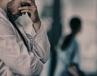 man holding head in hands in frustration